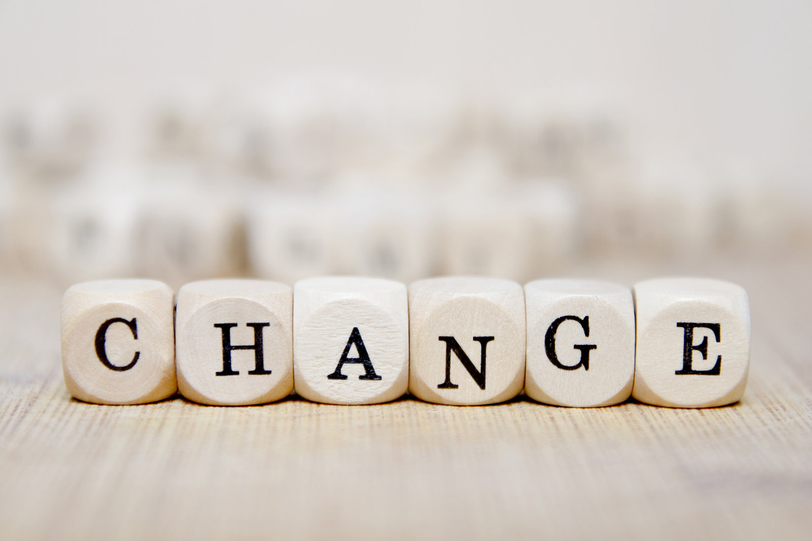 Wooden letter cubes arranged on a table to spell the word change