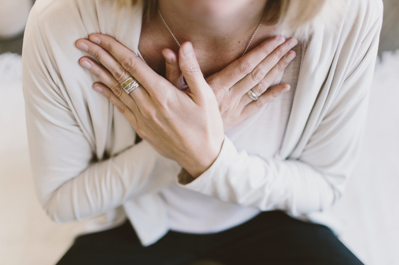 Close-up of a woman resting both hands crossed over her chest